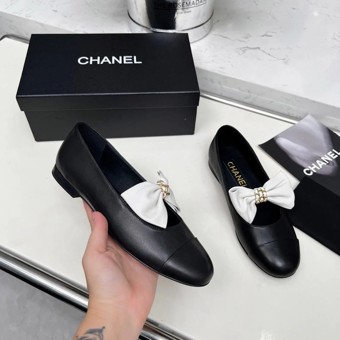 Chanel 25S Mary Janes In Black Calfskin With White Bow Gold Hardwre